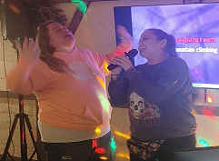 two women singing karaoke
