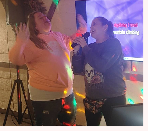 two women singing karaoke